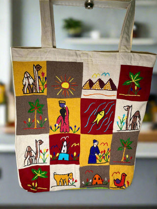 Tote bag with embroidered designs on a plain background