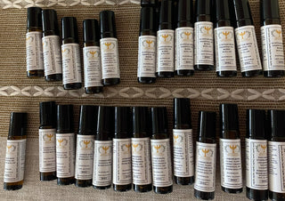 Multiple small bottles with labels arranged on a textured surface