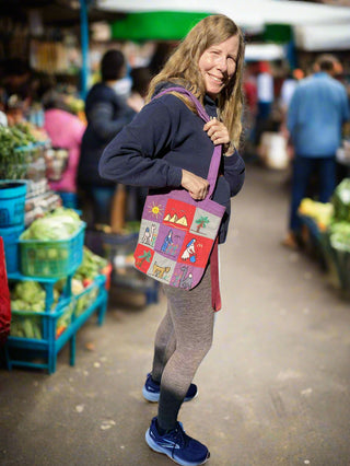 Woman holding a colorful bag in a market setting