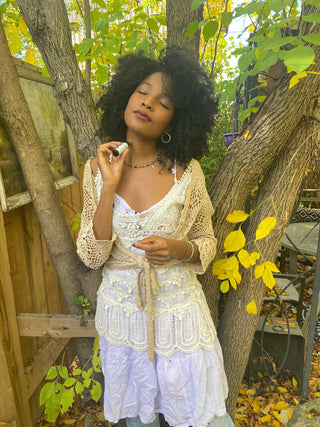 Girl rolling natural perfume onto her neck