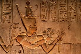 Ancient Egyptian holding lotus flowers