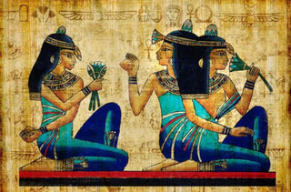 Egyptian hieroglyphic of a woman giving lotus flowers to another woman