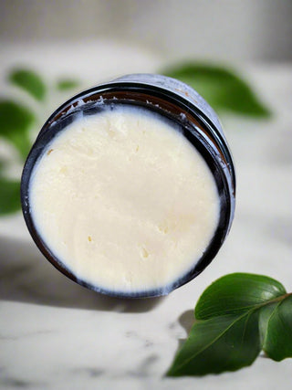 Bergamot Mood Boosting Butter Balm with leaves in the background