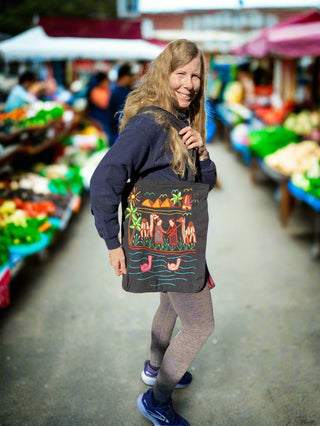 Woman with a colorful tote bag at an outdoor market