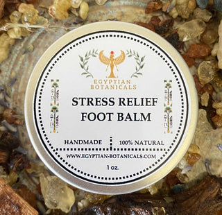 Egyptian Botanicals Stress Relief Foot Balm container on a natural stone background