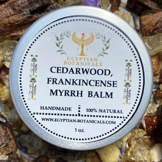 Balm container labeled 'Cedarwood, Frankincense Myrrh Balm' by Egyptian Botanicals on a natural background.