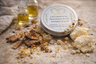 Cedarwood Frankincense Myrrh Balm with ingredients on a textured surface