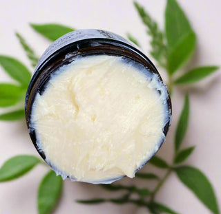 Citrus Energy Butter Balm with leaves in the background