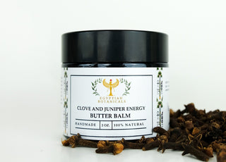 Clove and Juniper Berry Energy Boosting Butter Balm with cloves in the background