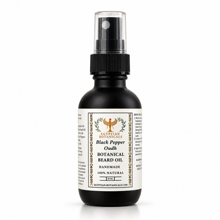 A bottle of Egyptian Botanicals Black Pepper Oudh Beard Oil, featuring a dark amber glass bottle with a black spray nozzle and a white label with gold and black text.
