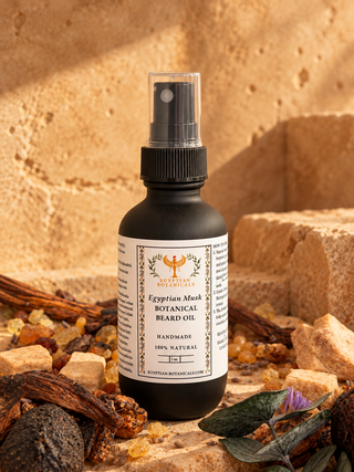 A bottle of Egyptian Botanicals Egyptian Musk Botanical Beard Oil, styled with natural ingredients like beard wax, rose, and herbs on a textured sandy background.