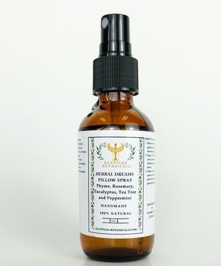 A brown bottle with a spray nozzle labeled Herbal Dreams Pillow Spray with a white label that lists the ingredients such as Thyme, Rosemary, Eucalyptus, Tea Tree, and Peppermint.
