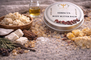 Hibiscus body butter balm with ingredients on a textured surface
