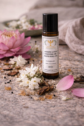 Essential oil roller bottle with flowers and petals on a textured surface