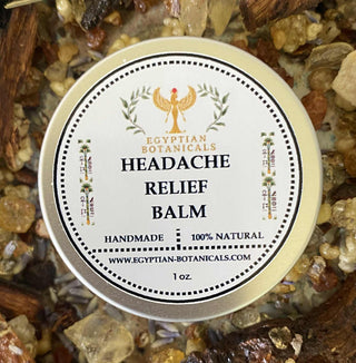 Headache relief balm container with label on a bed of herbs and natural ingredients