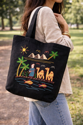 Person at a park carrying a Black Tote Bag With Fish in the Nile River