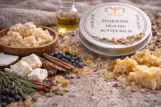 Pharaonic Healing Butter Balm with ingredients on a textured surface