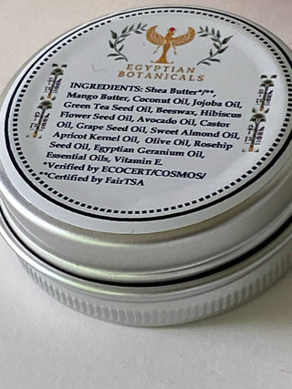 Tin of Egyptian Botanicals product with label showing ingredients on a light background