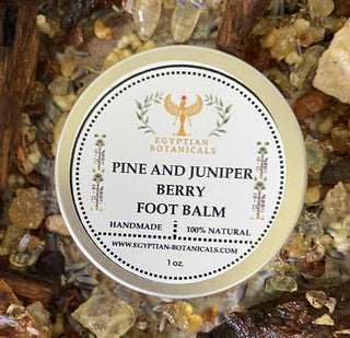 Pine and Juniper Berry Foot Balm container with label on a natural stone background